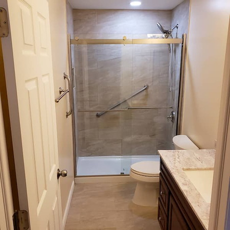 What are the benefits of a curbless shower for accessibility and aging in place